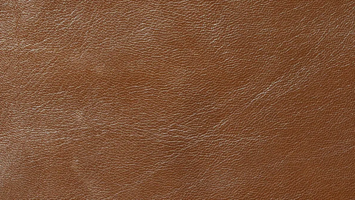 Close-up of tan goatskin leather showing its fine natural grain